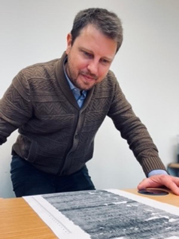 James D. Moore looking over a text